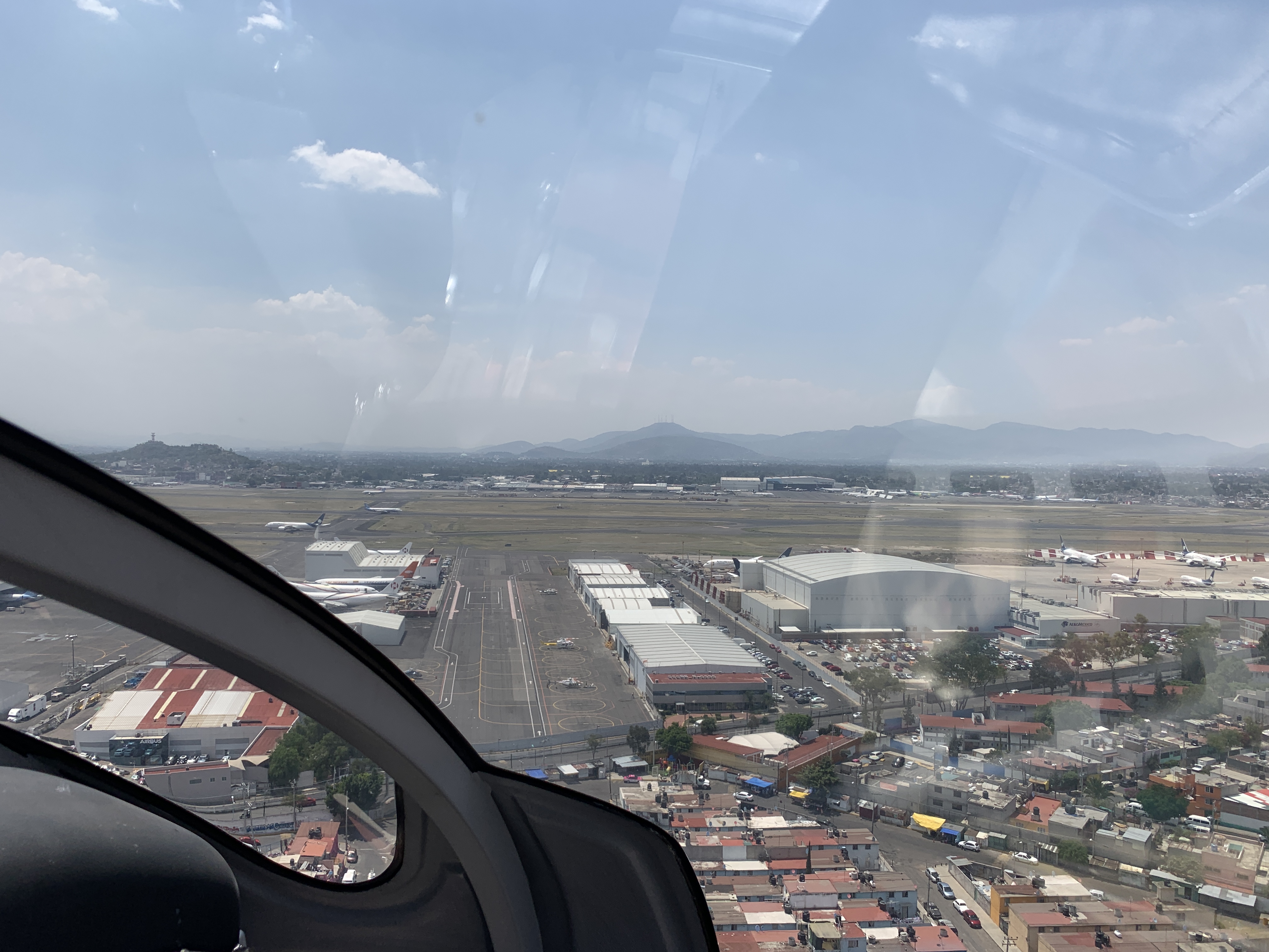 an airplane window with a city and buildings