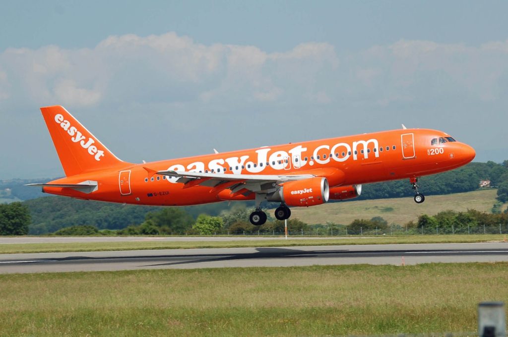an orange airplane taking off
