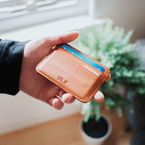 a hand holding a wallet