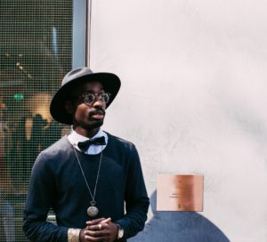 a man wearing a hat and bow tie