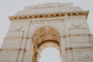 a large stone arch with a blue sky