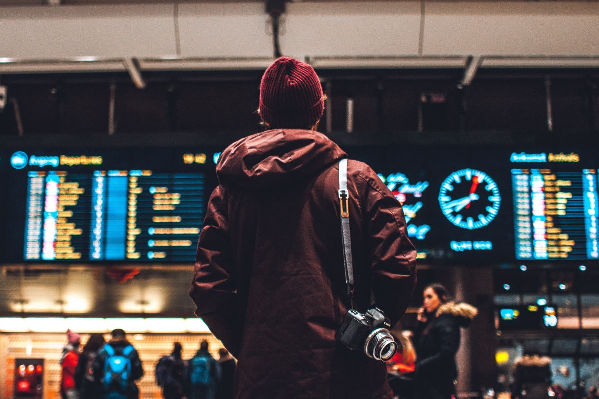 a person in a red beanie with a camera