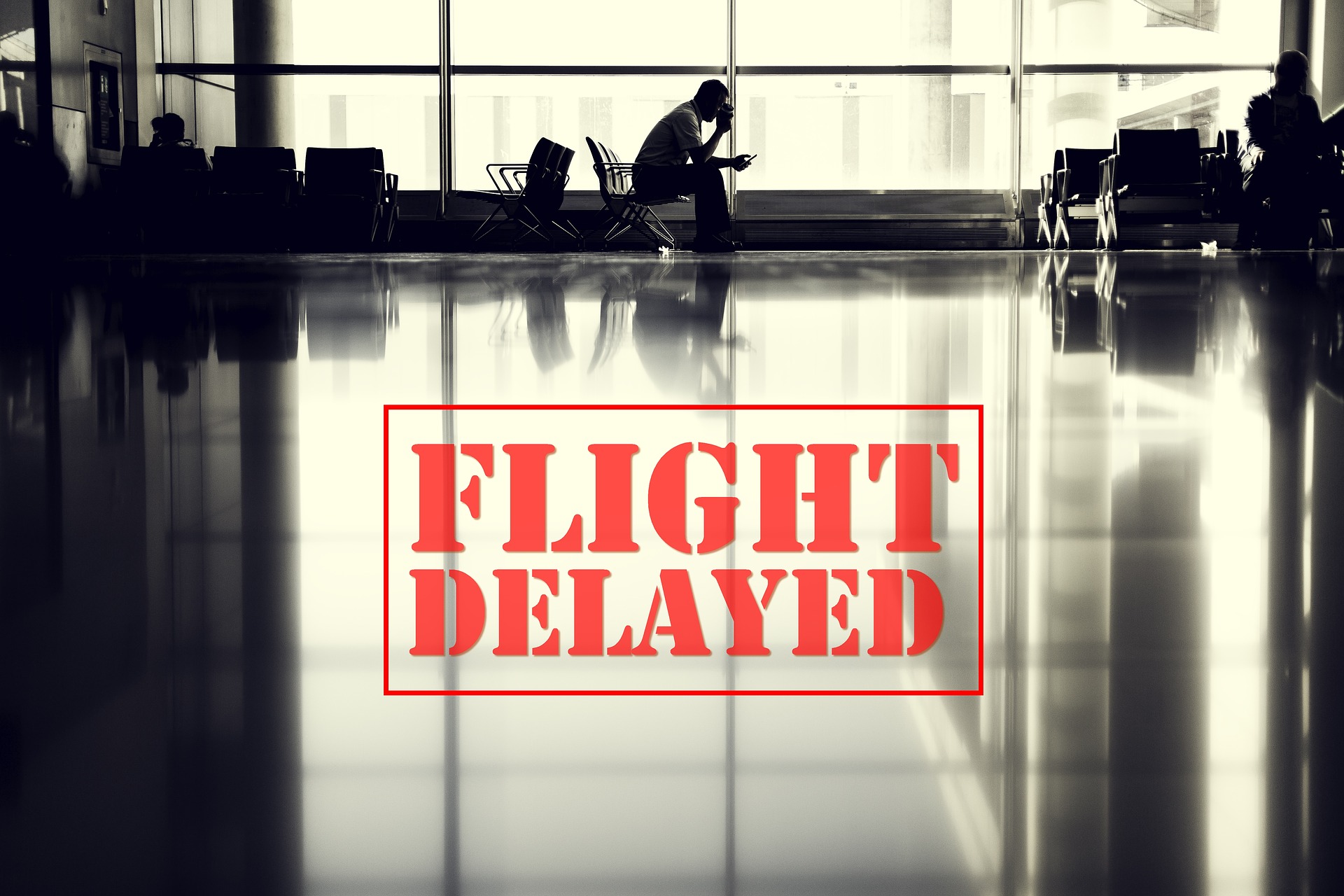 a man sitting in a chair in an airport