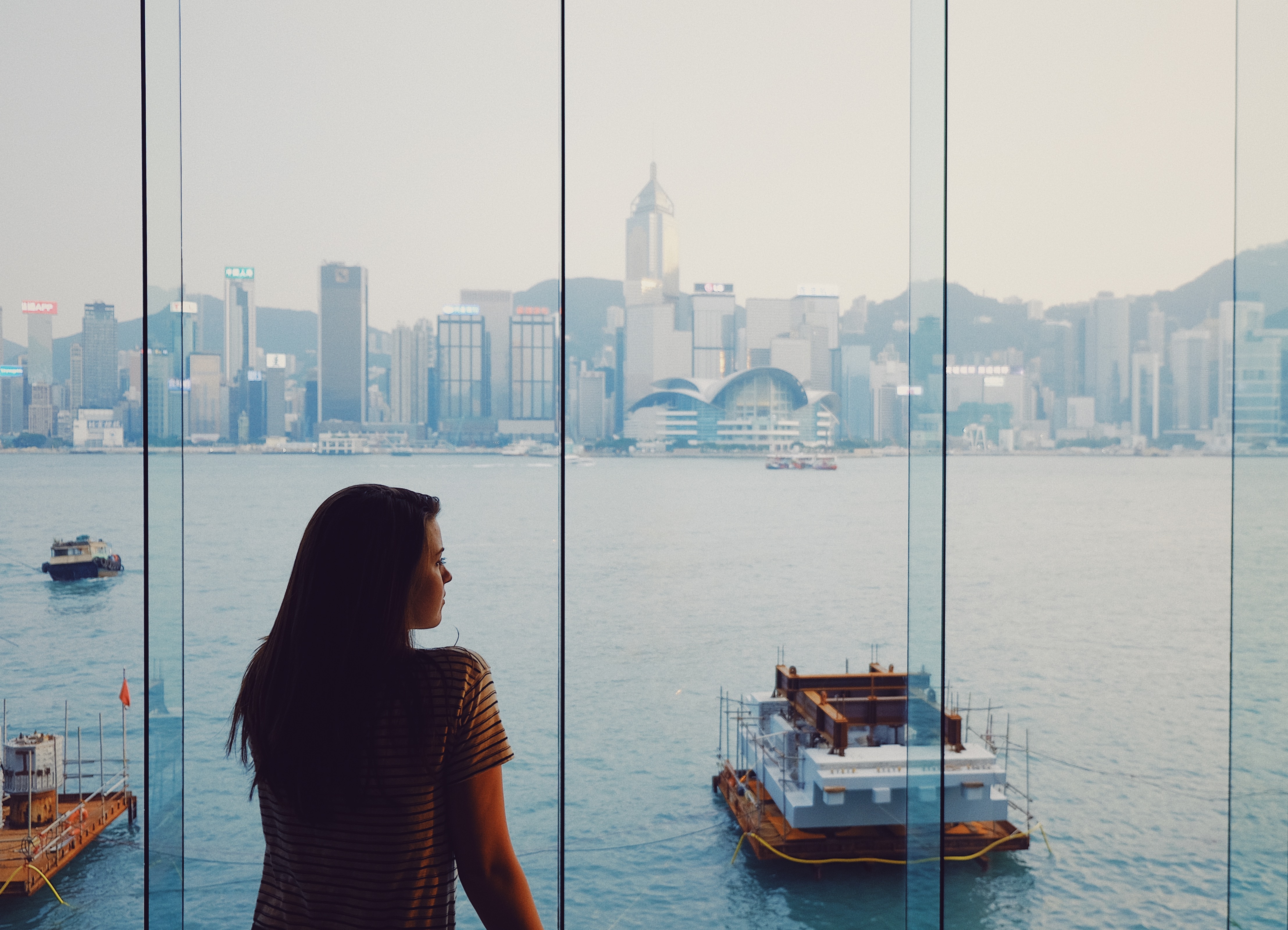 a woman looking at a boat in the water