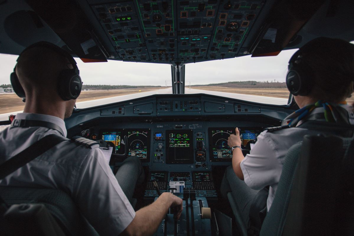 a group of people in the cockpit of an airplane