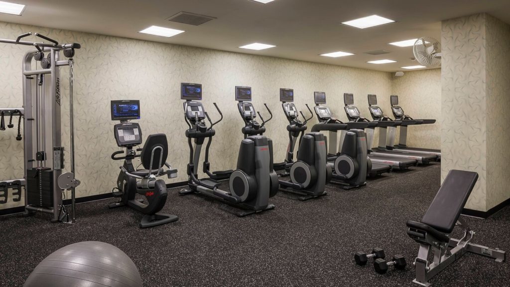 a room with exercise machines and exercise balls