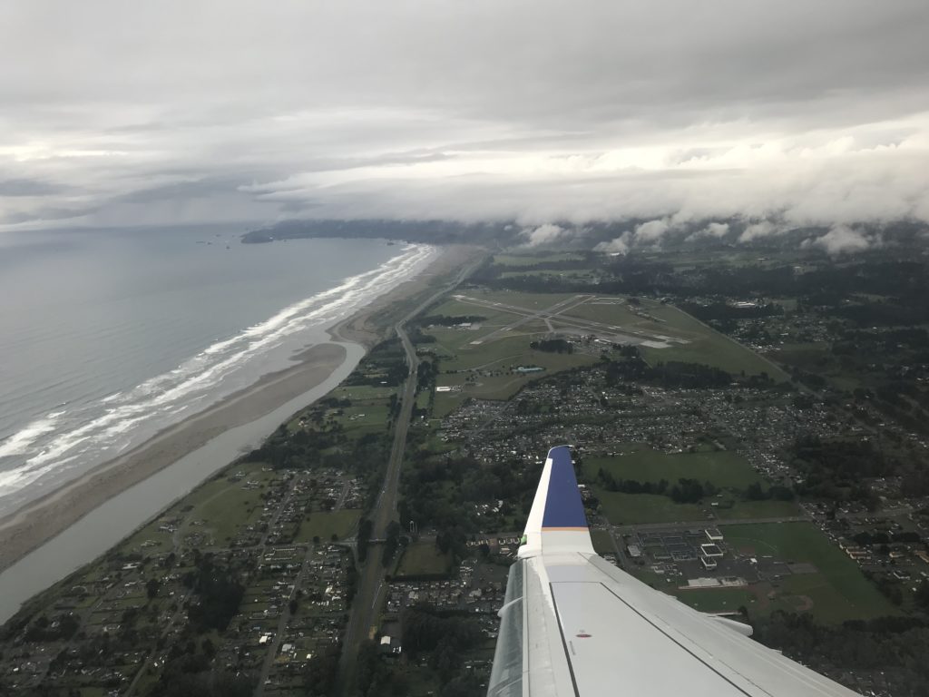 an airplane wing over a beach