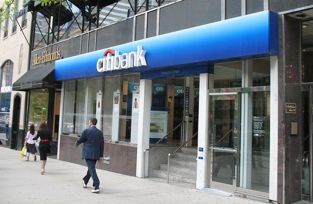 a man walking past a bank