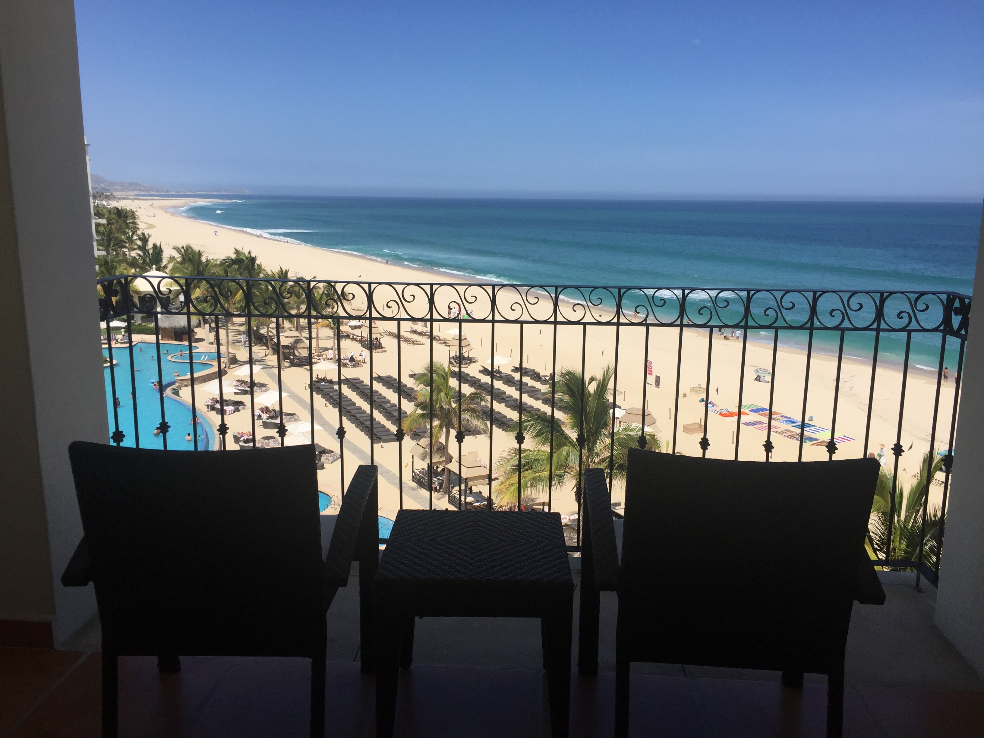 chairs on a balcony overlooking a beach