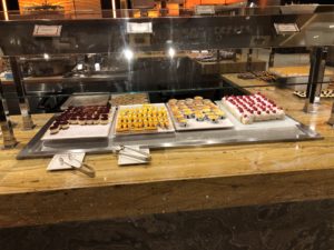 a display case with different colored cakes