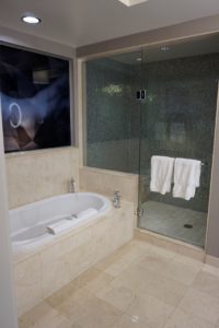 a bathroom with a glass shower and bathtub