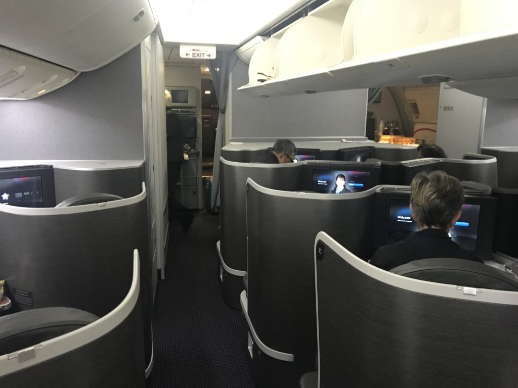 a group of people sitting in chairs in an airplane