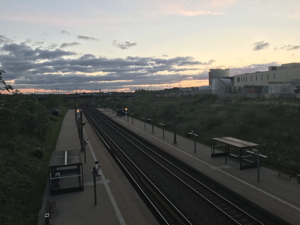 a train tracks next to a train station