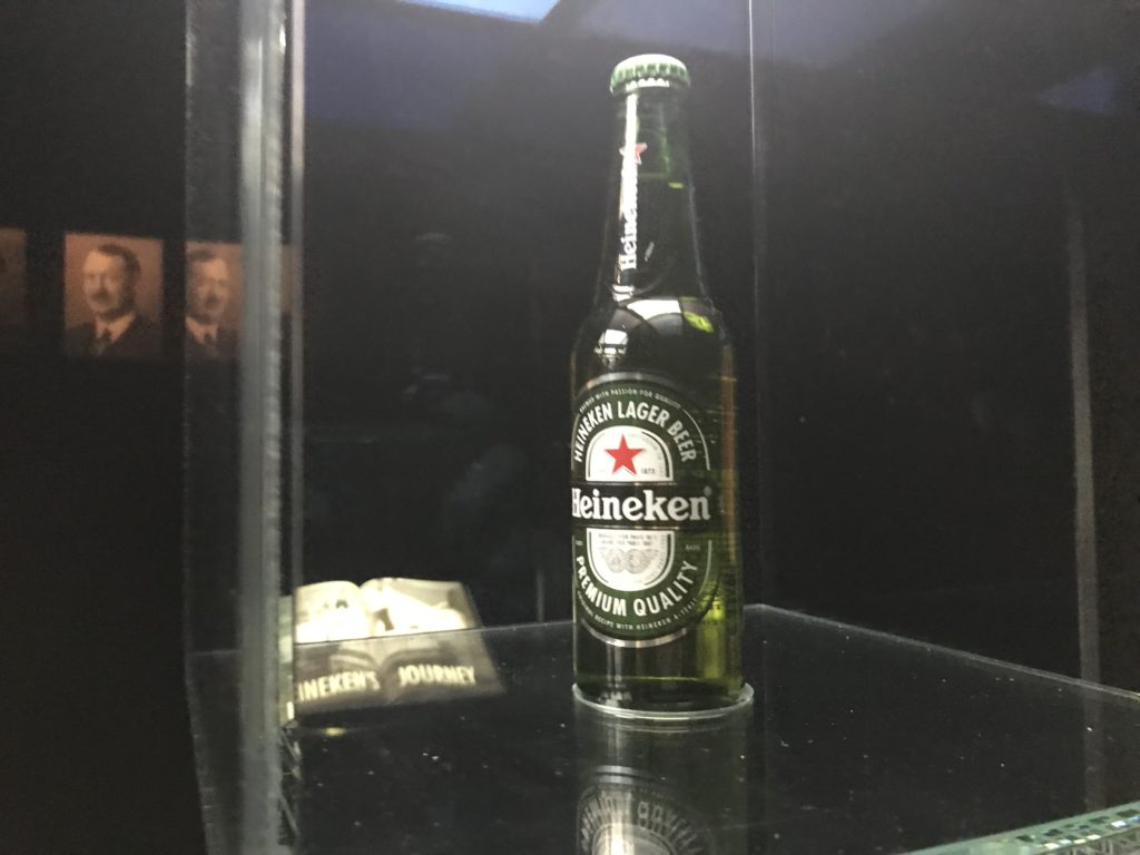 a bottle of beer on a glass shelf
