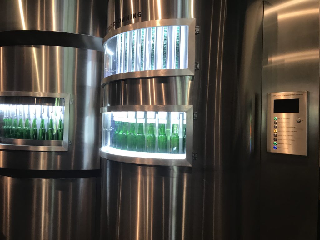 a group of bottles in a glass case