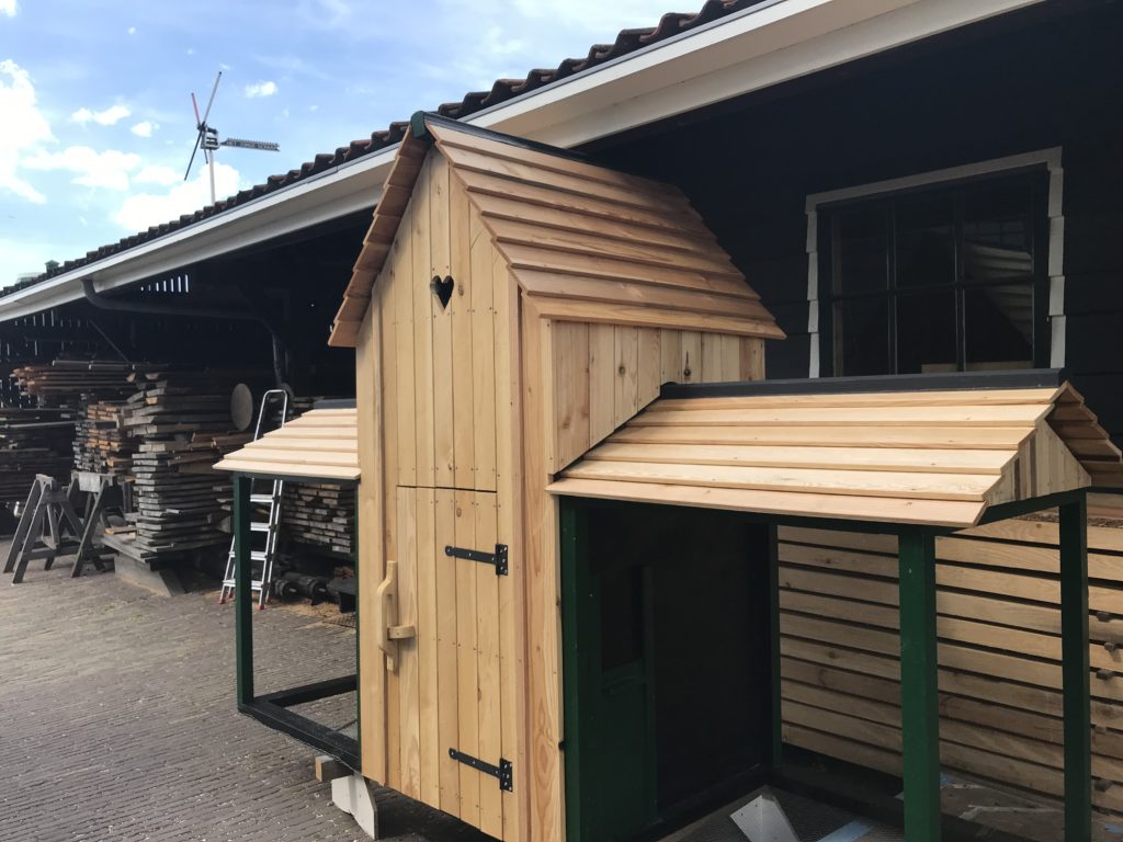 a wooden shed outside of a building