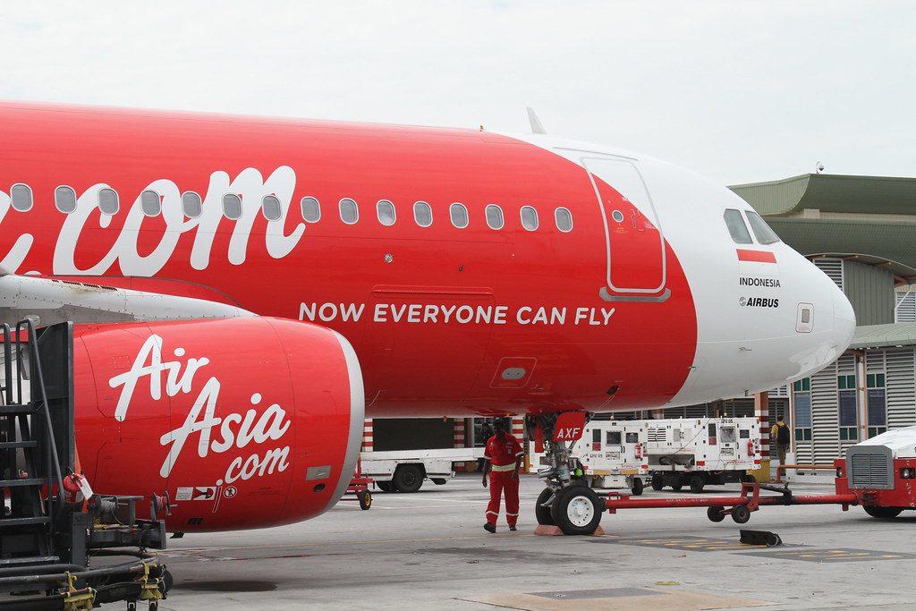 a red and white airplane with white text on it