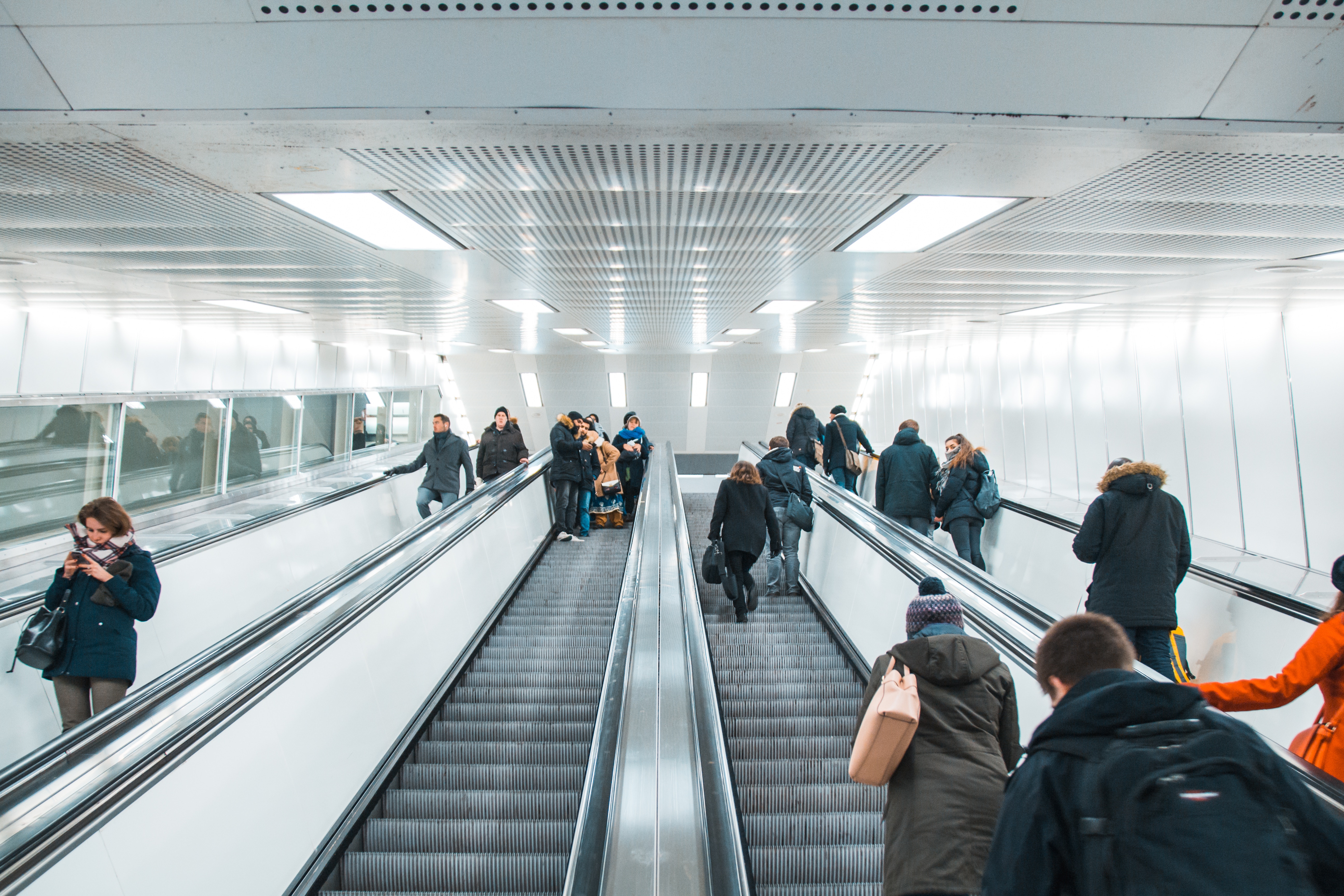 a group of people on an escalator