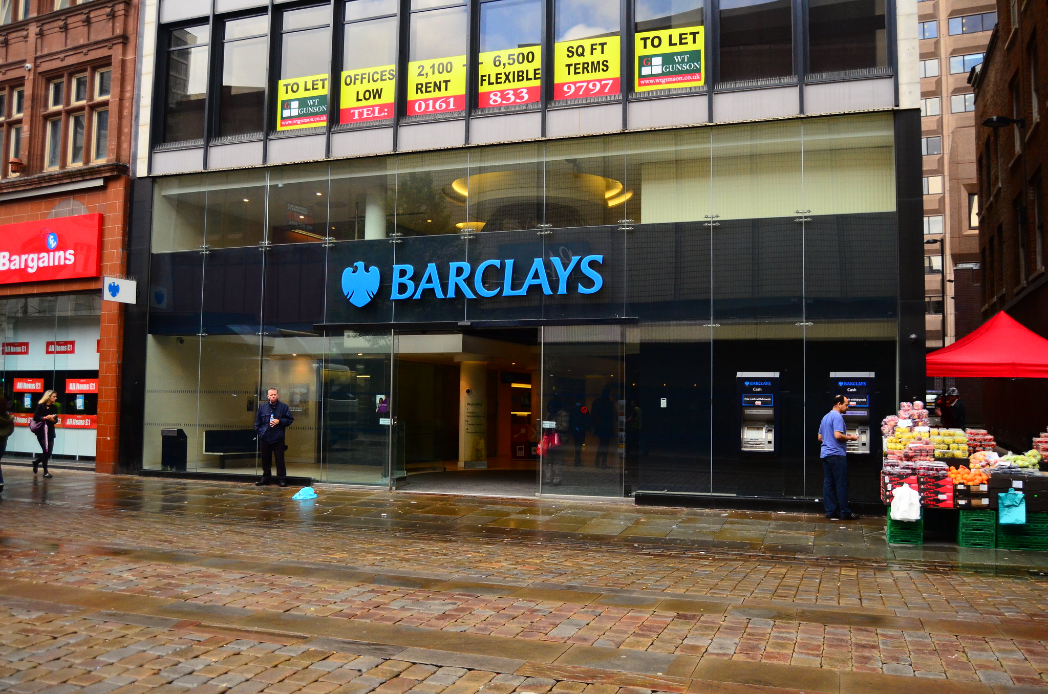 a building with a glass front with a sign on it