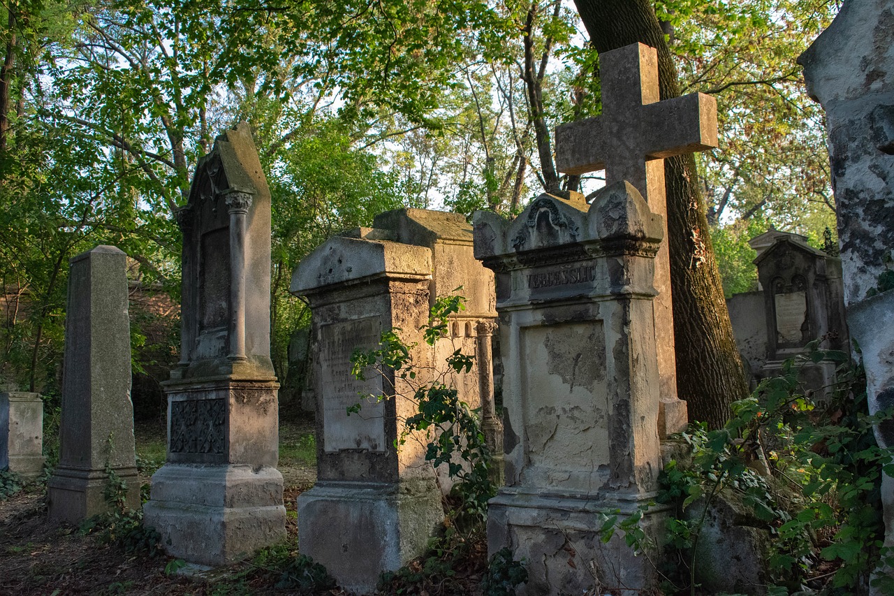 a group of gravestones with a cross in the middle