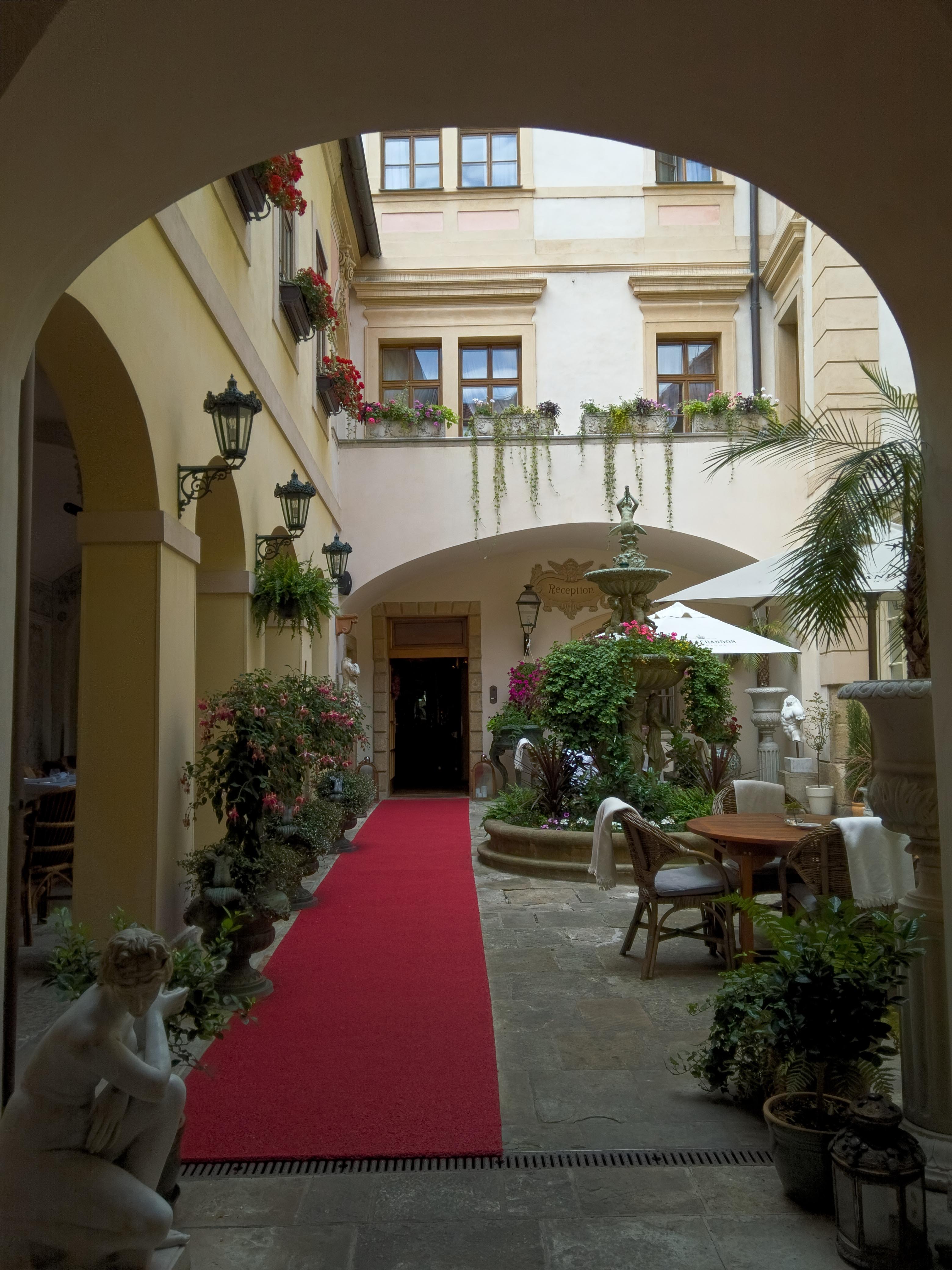 a courtyard with a red carpet and a red carpet