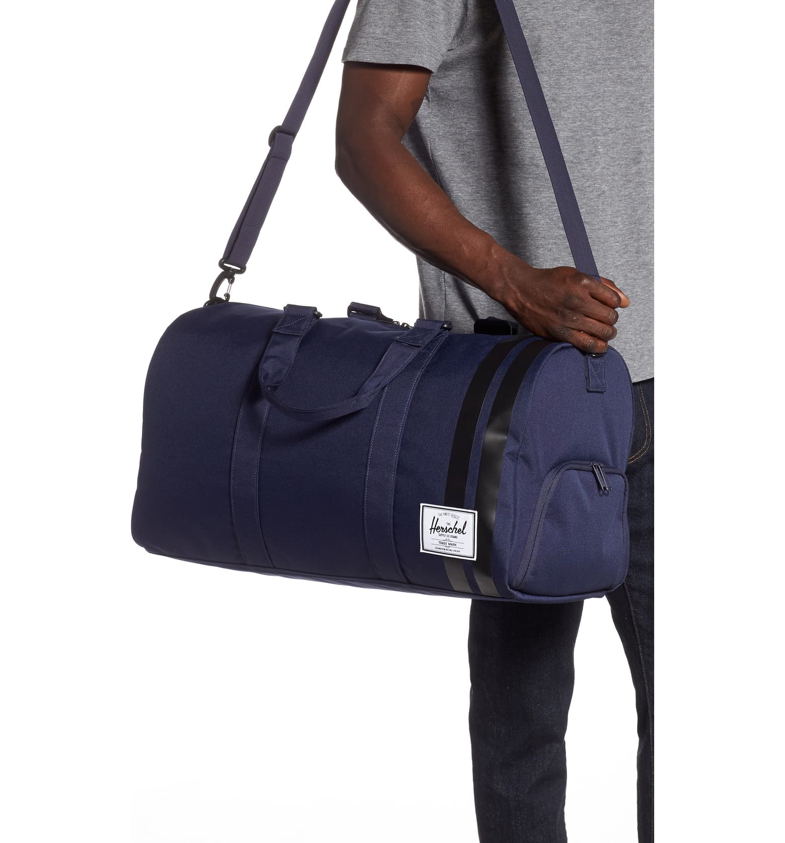 a person holding a blue duffel bag