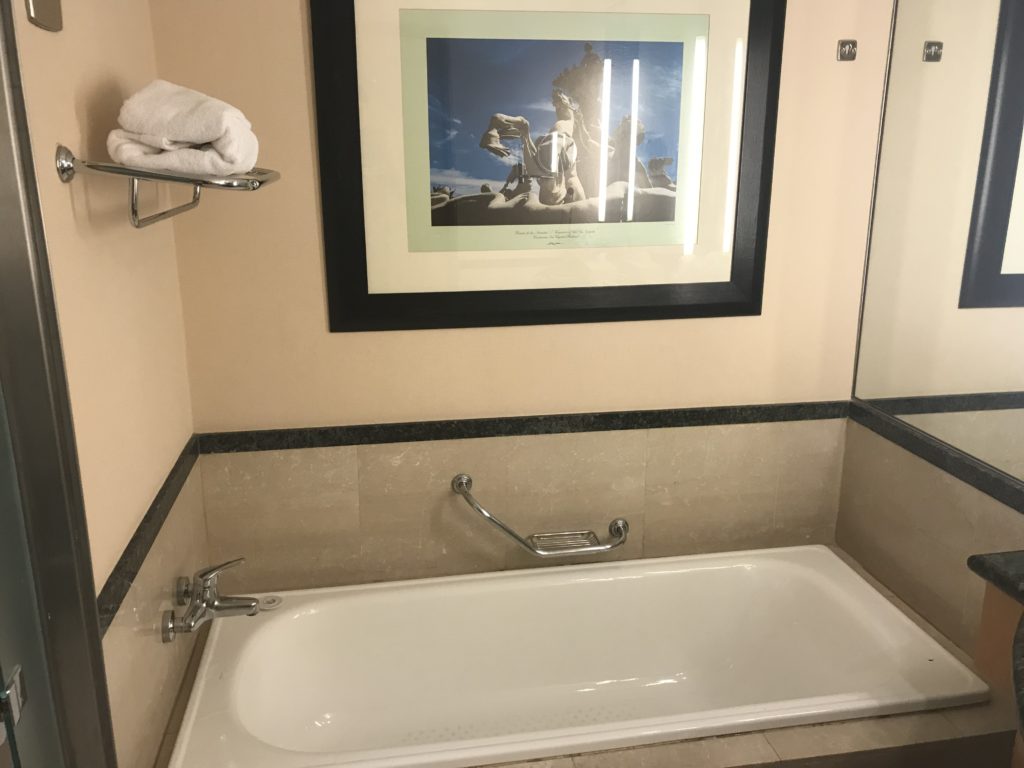 a bathtub and towel on the wall