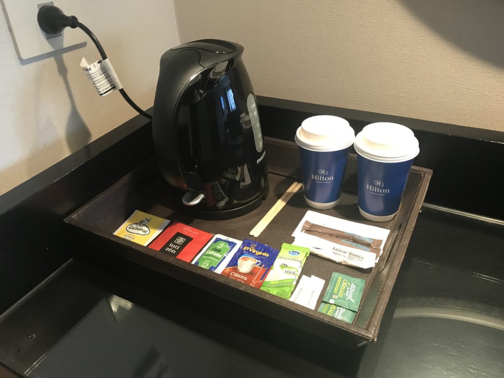 a tray with a coffee pot and tea cups on it