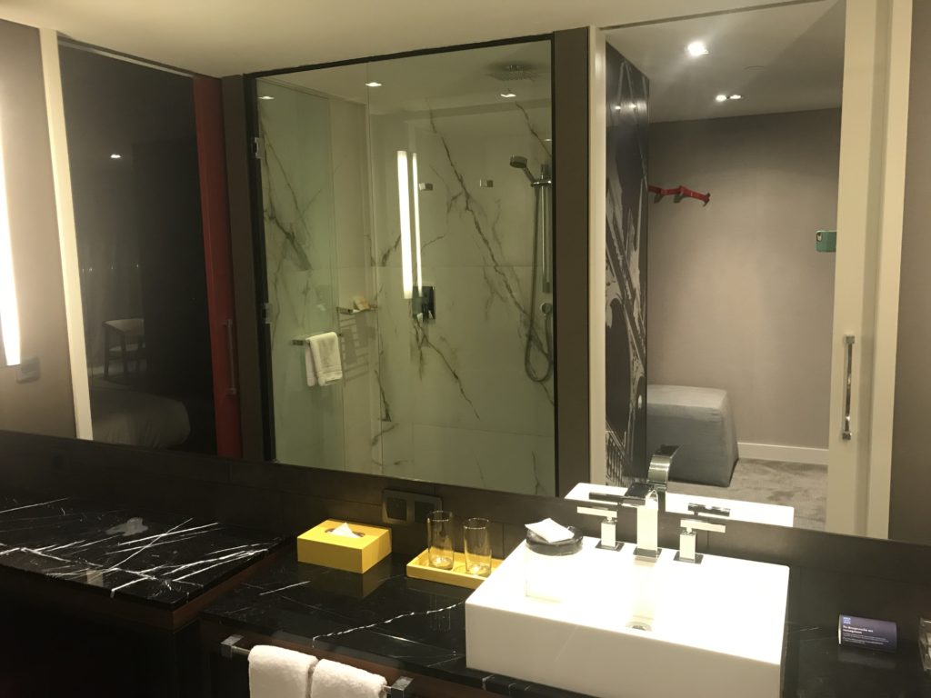 a bathroom with a glass shower and sink