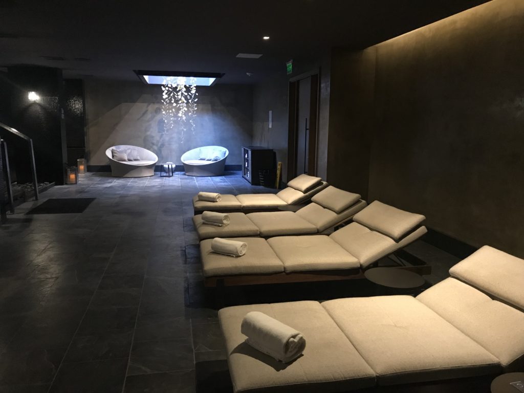 a room with lounge chairs and tubs
