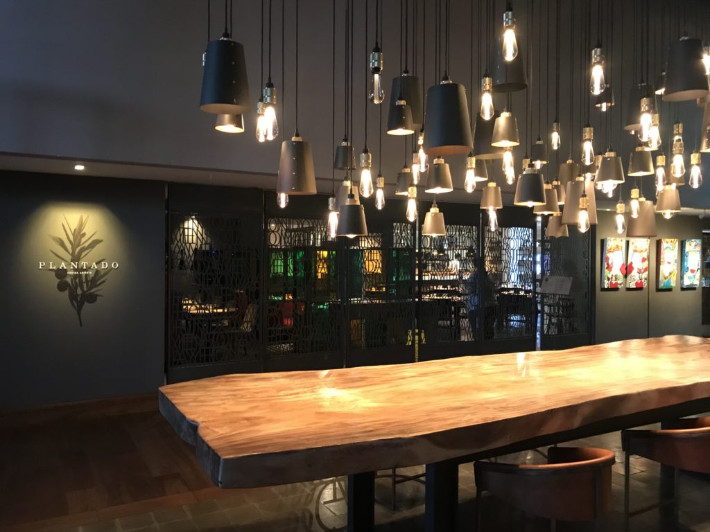 a table with lights from the ceiling