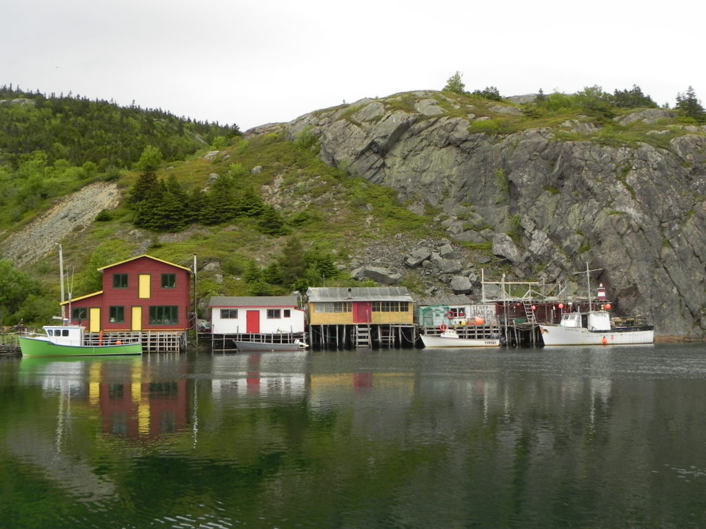 a group of houses on stilts on a body of water