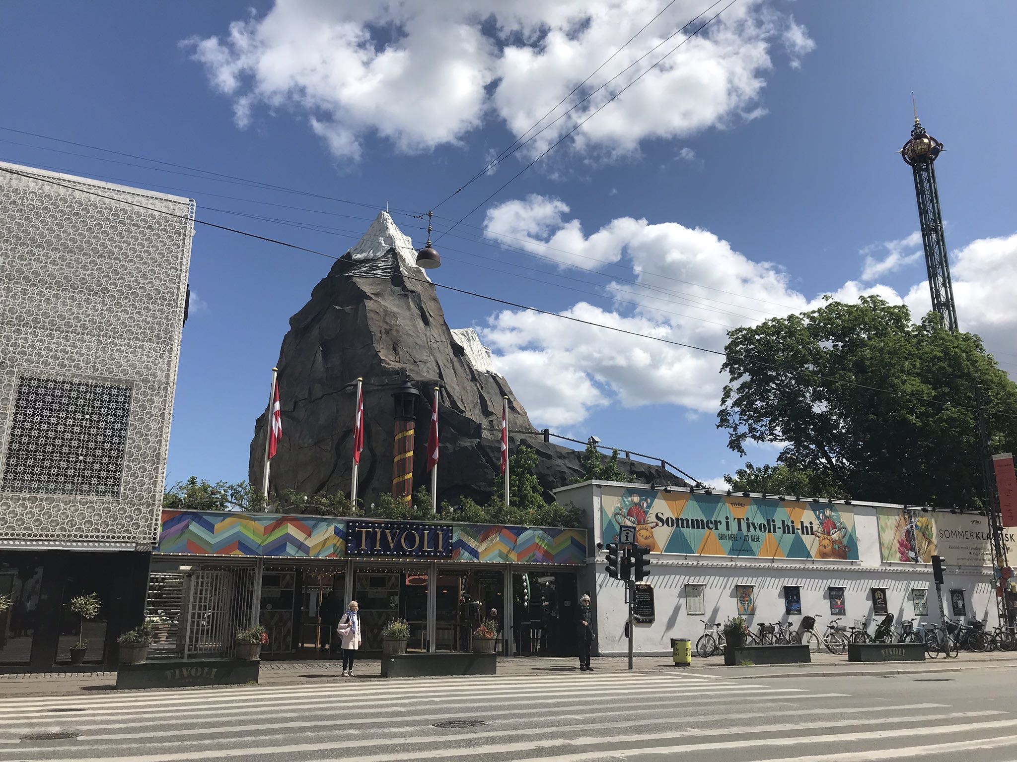 a building with a large rock in the background