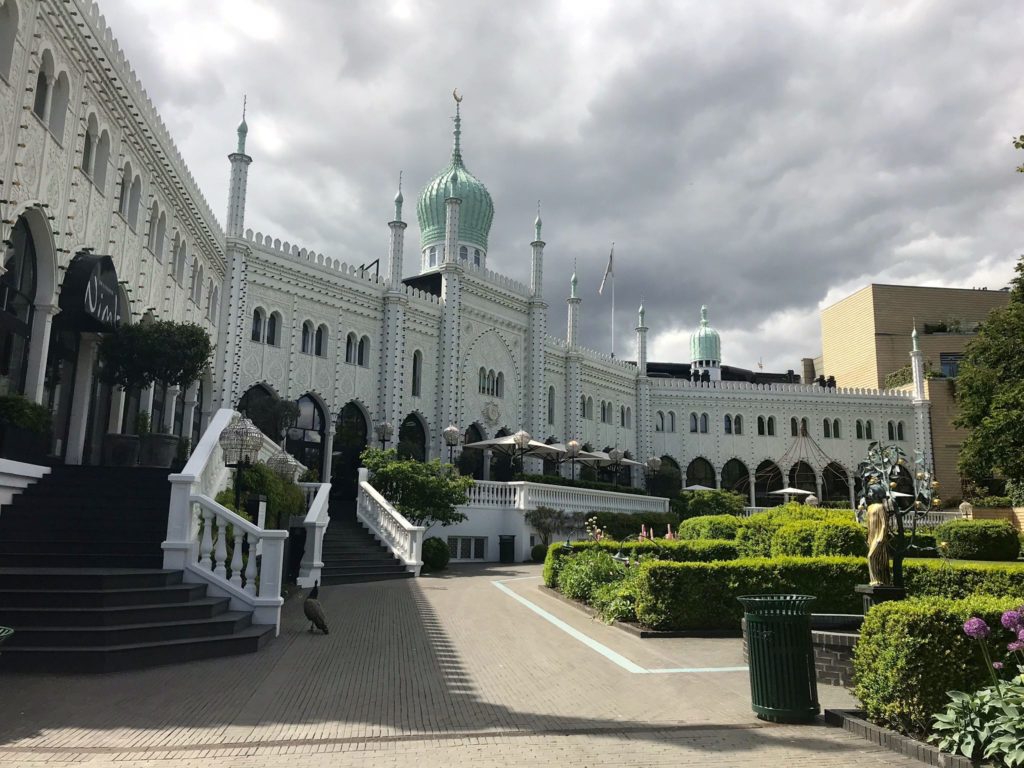 a white building with green domes and a green roof