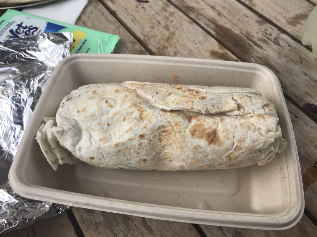 a burrito in a styrofoam container
