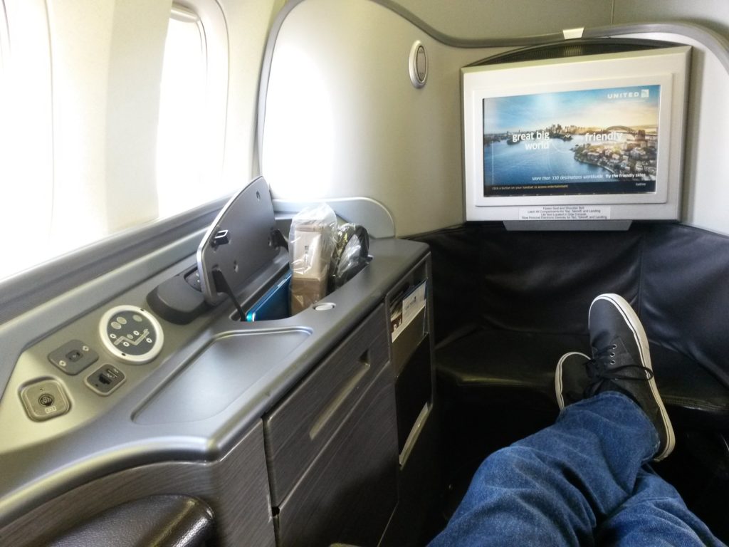 a person's feet in a chair in an airplane
