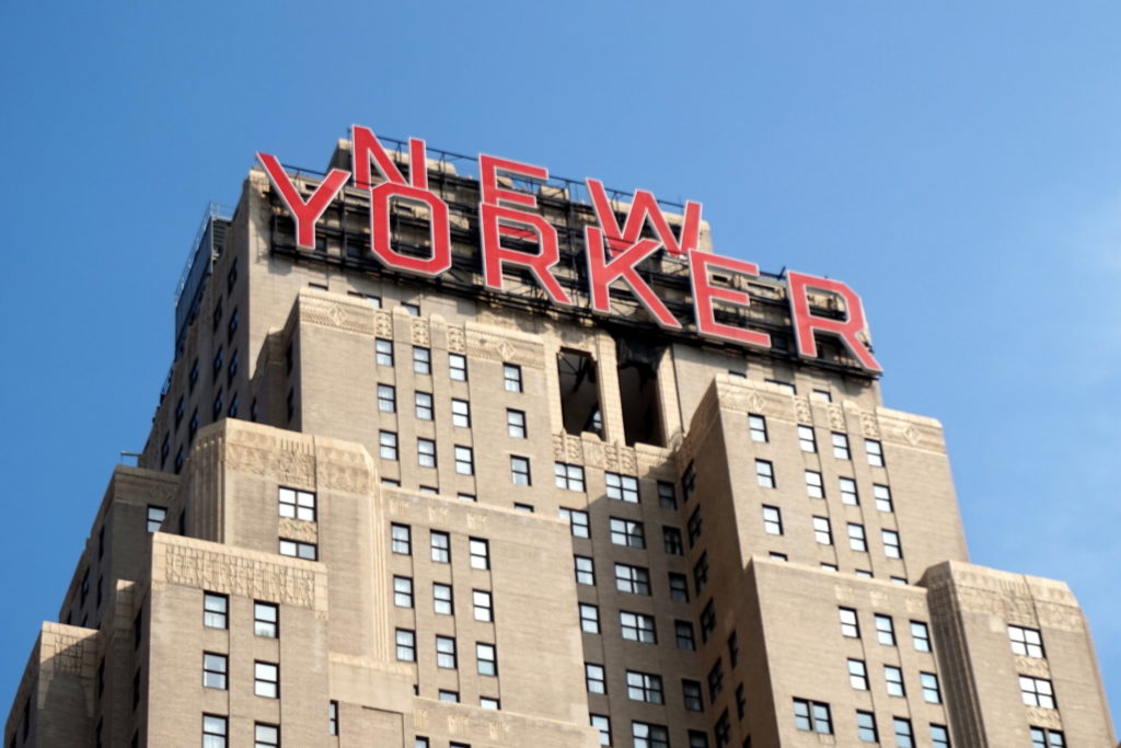 a large building with red letters on top with Union Station in the background