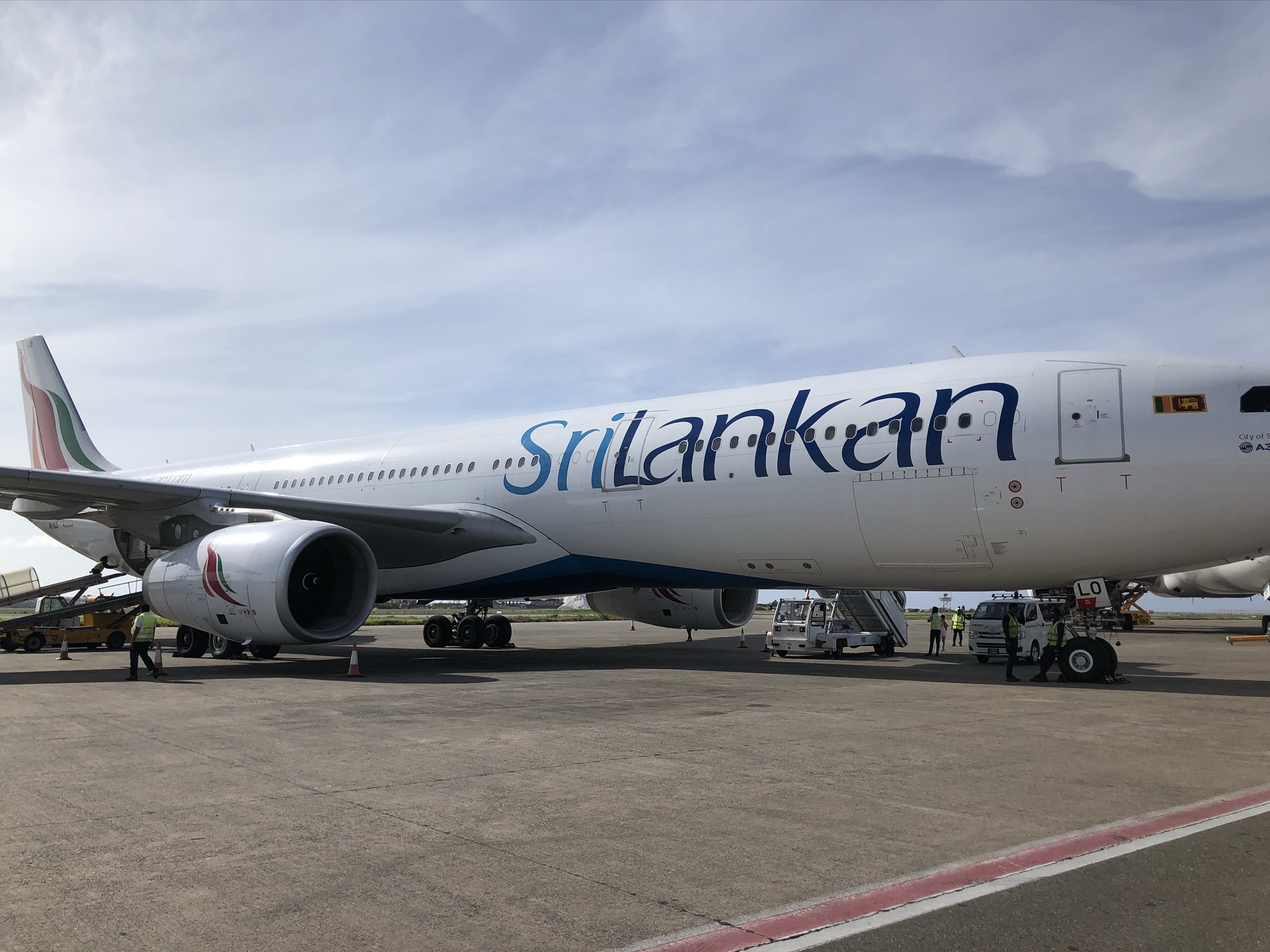 a large white airplane with blue writing on it