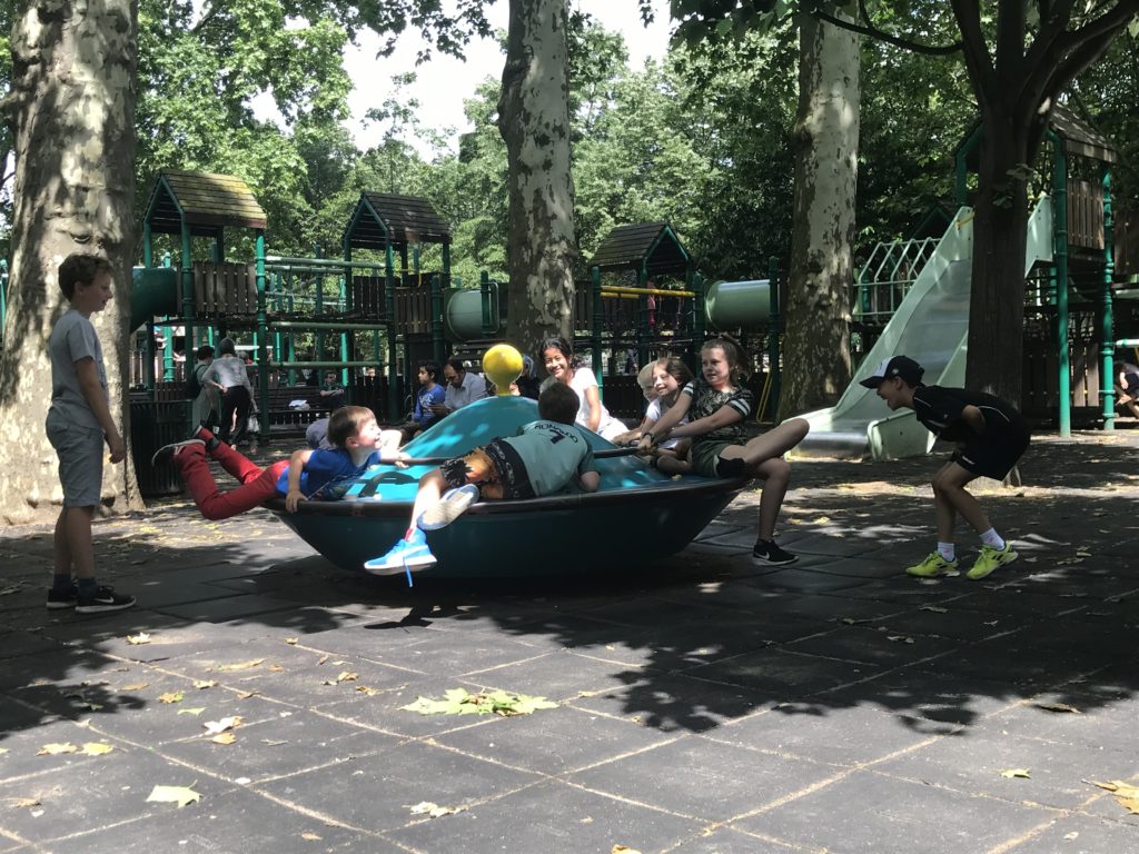a group of kids on a boat at a playground