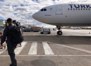 a man walking towards an airplane