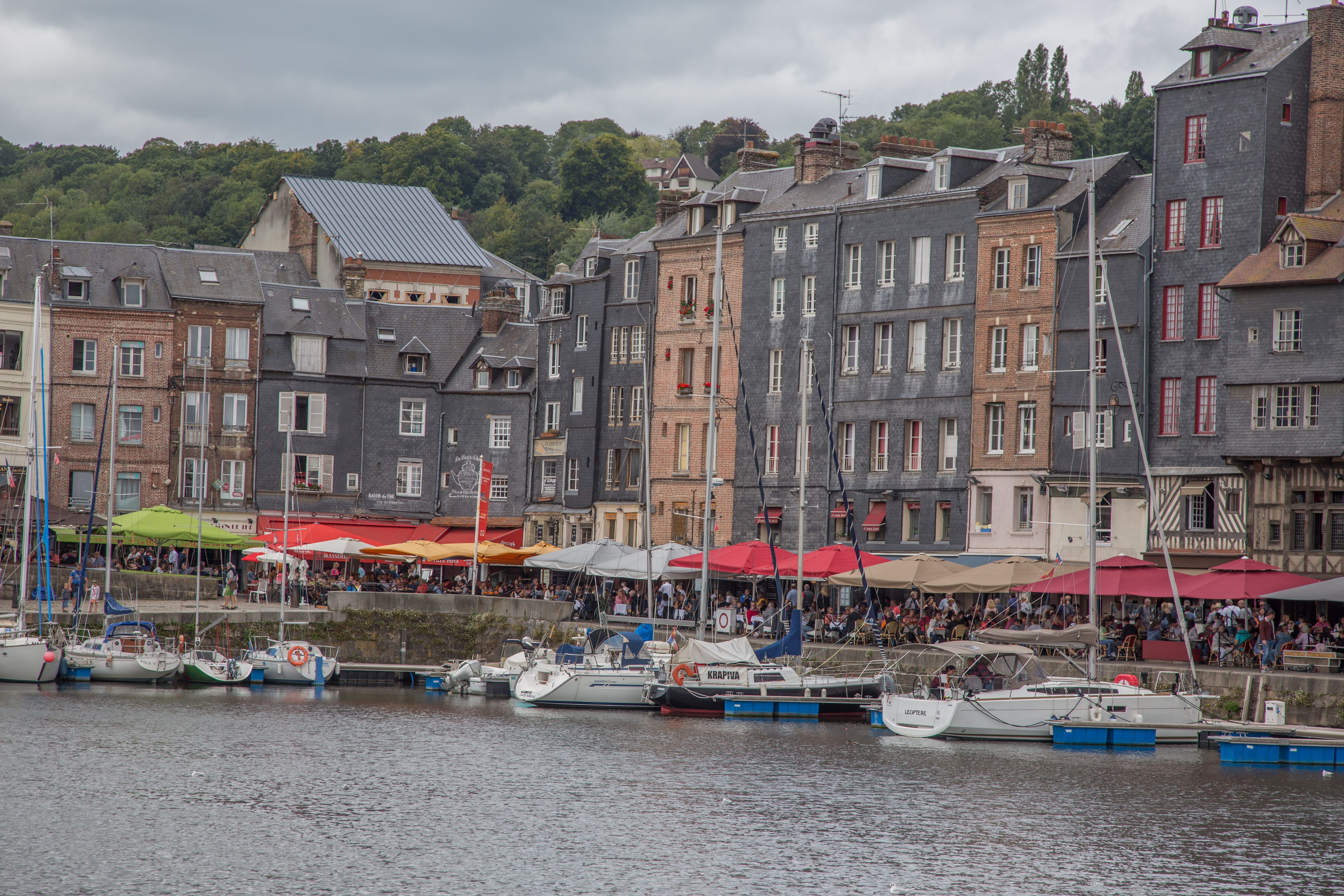 boats on the water with Anne Frank House in the background