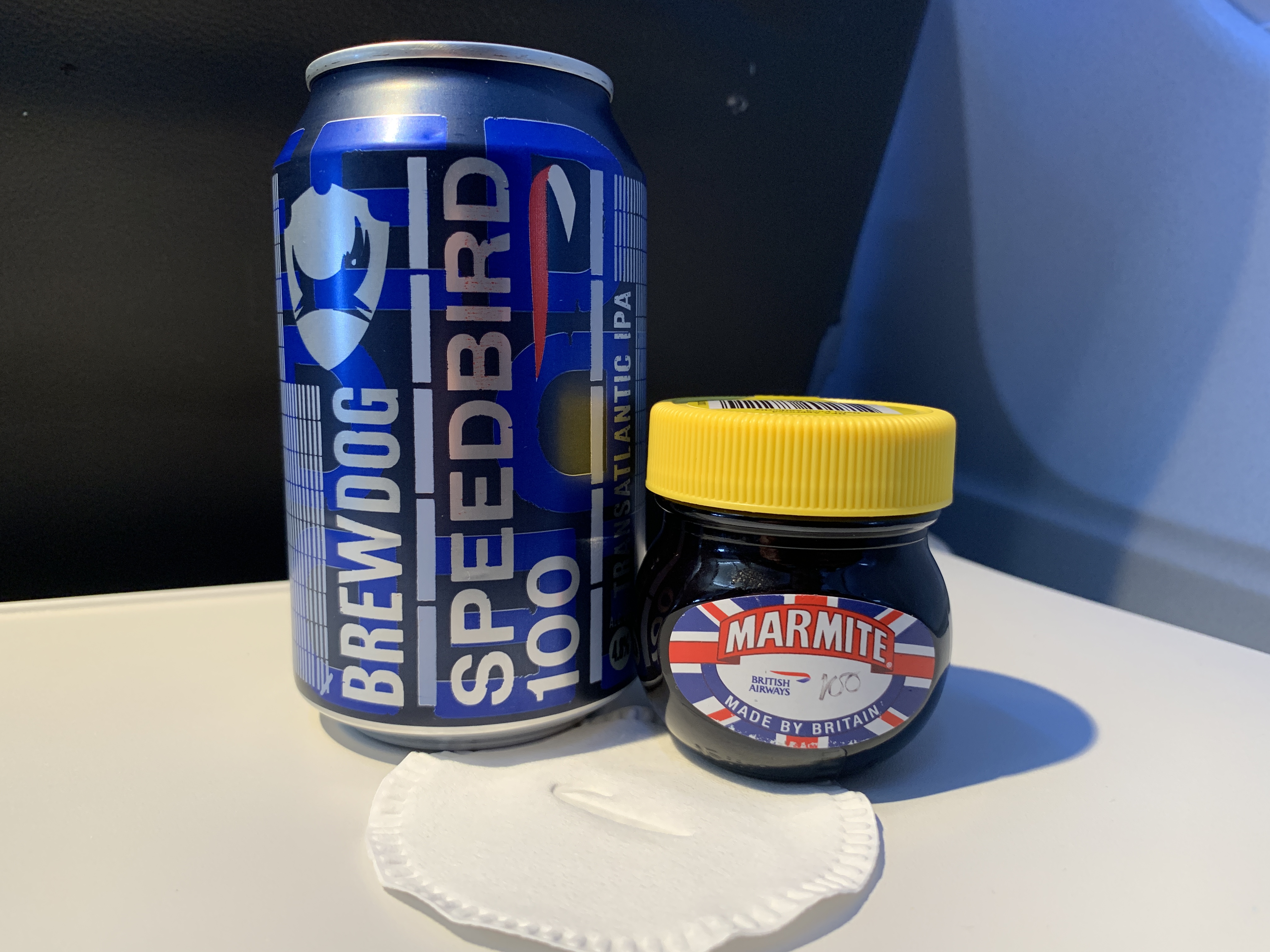 a blue can and a jar of marmite