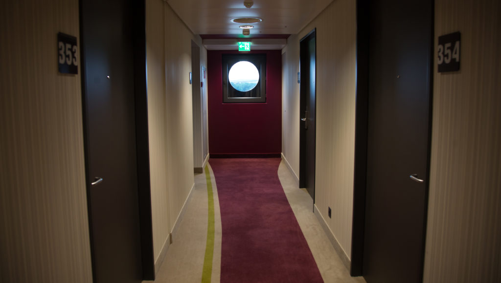 a hallway with a round window