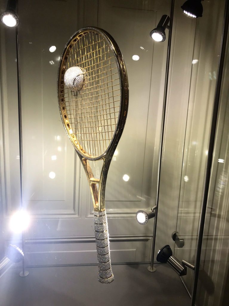 a tennis racket with a ball on it