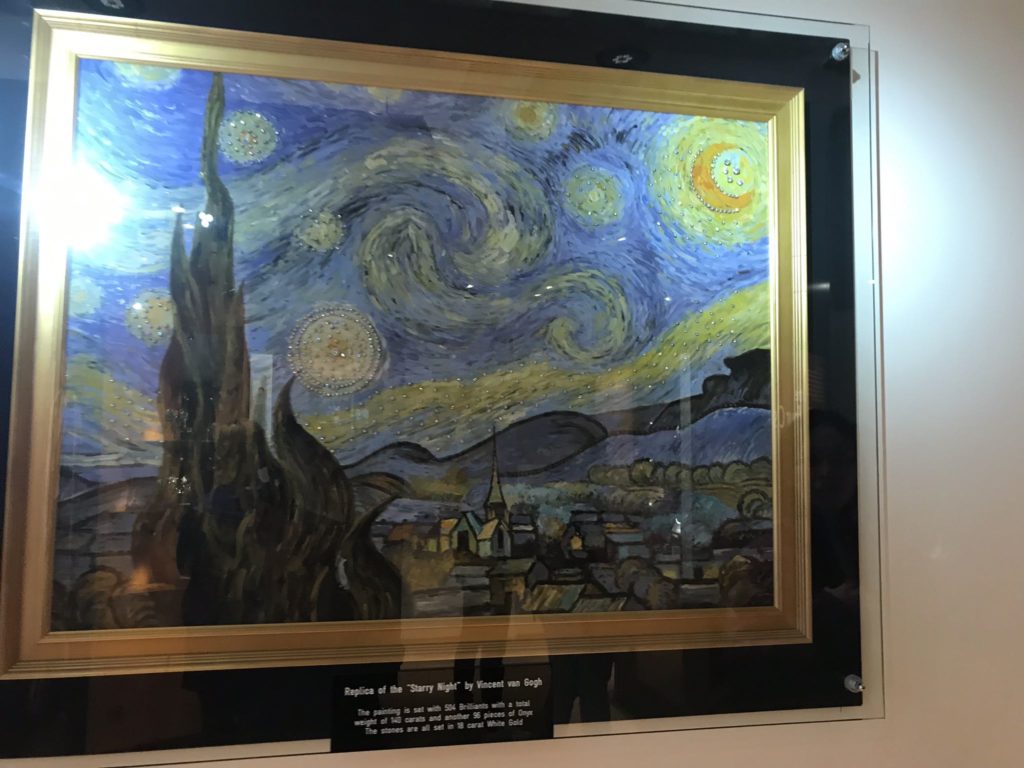 a framed painting of a starry night