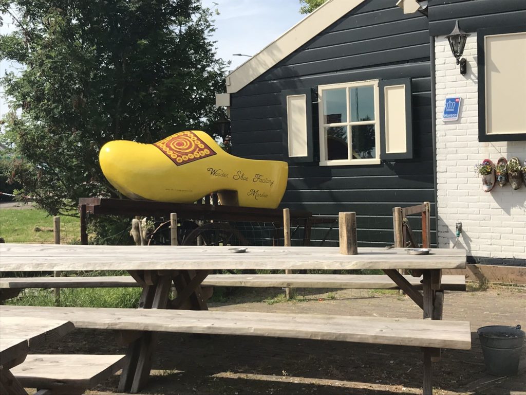a yellow shoe on a table outside a building