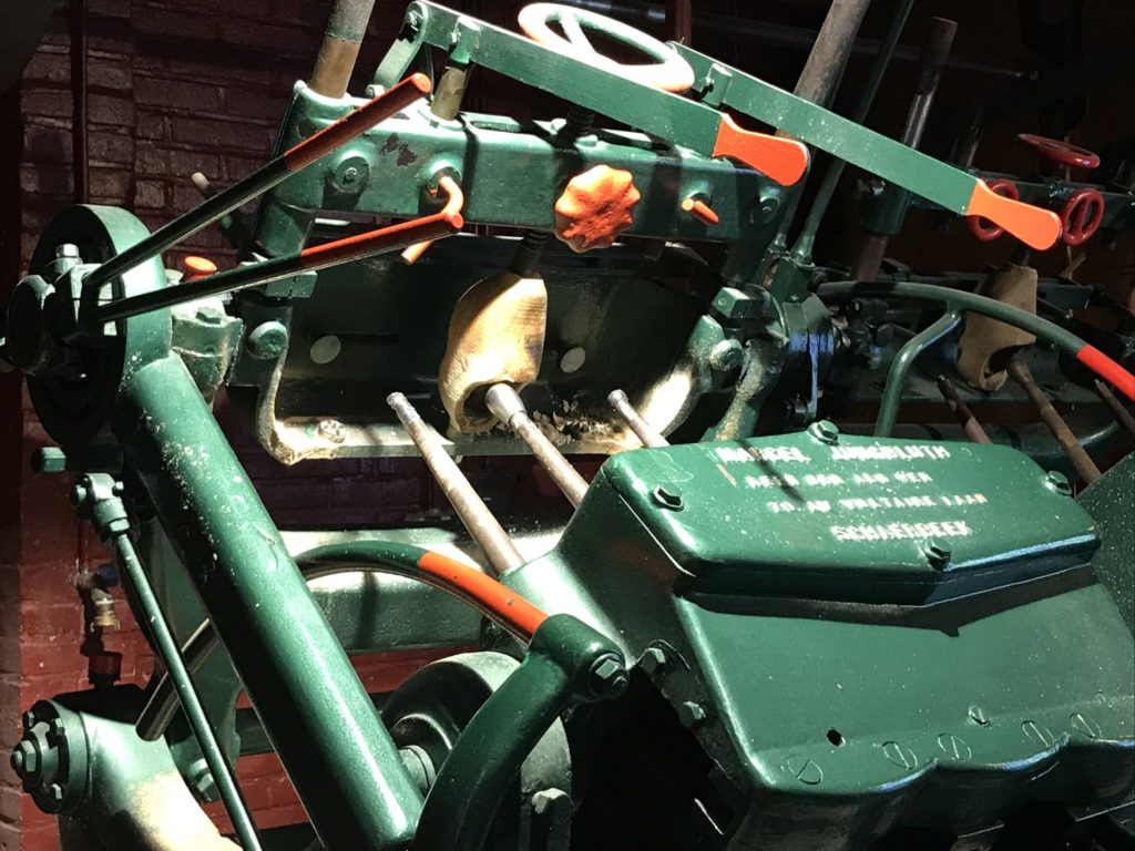 a green machine with orange handles
