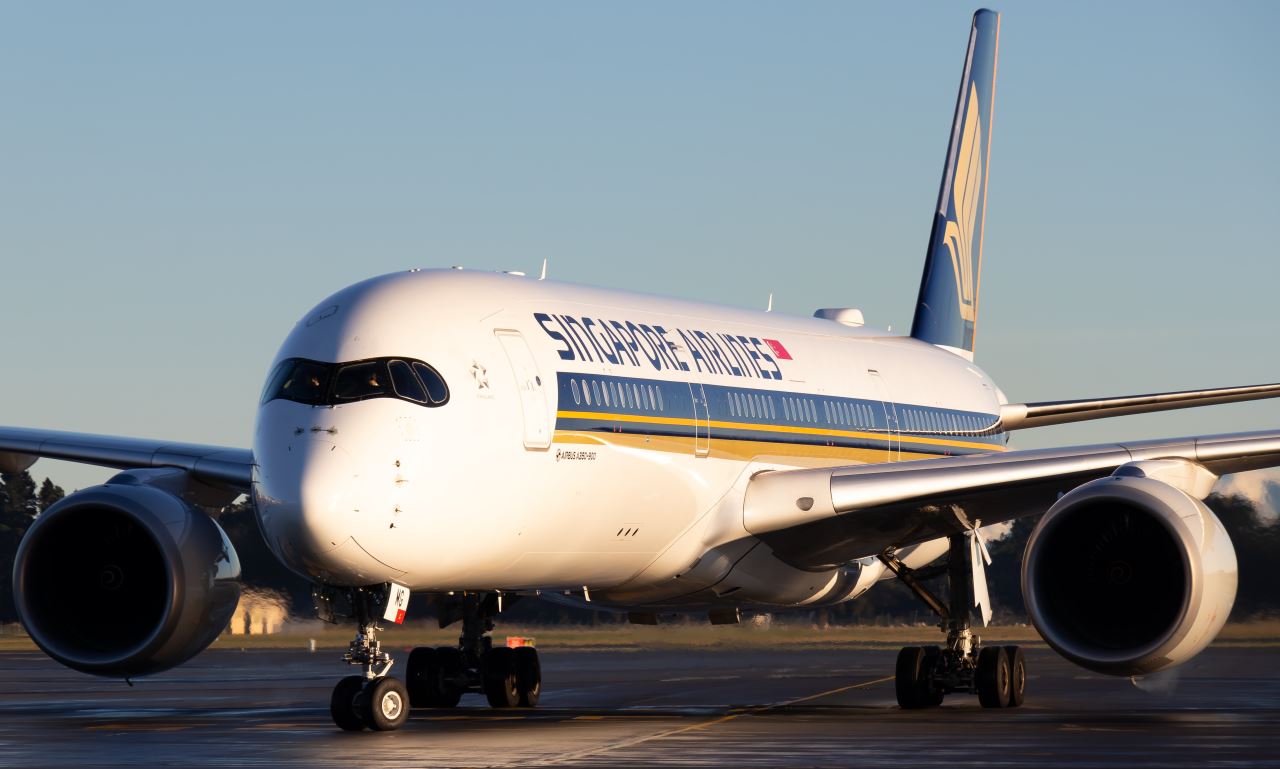 a large white airplane on a runway