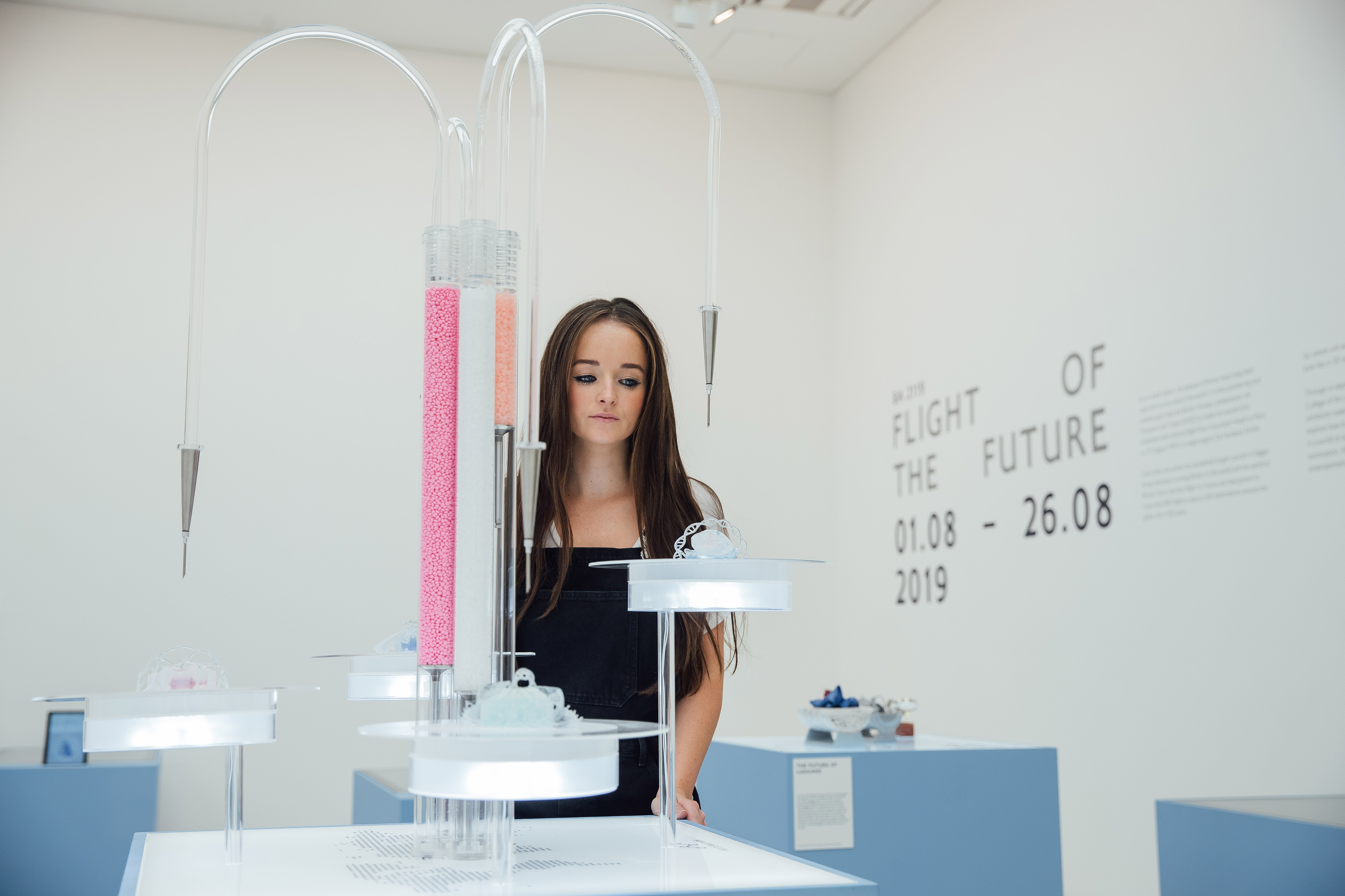 a woman standing in front of a display