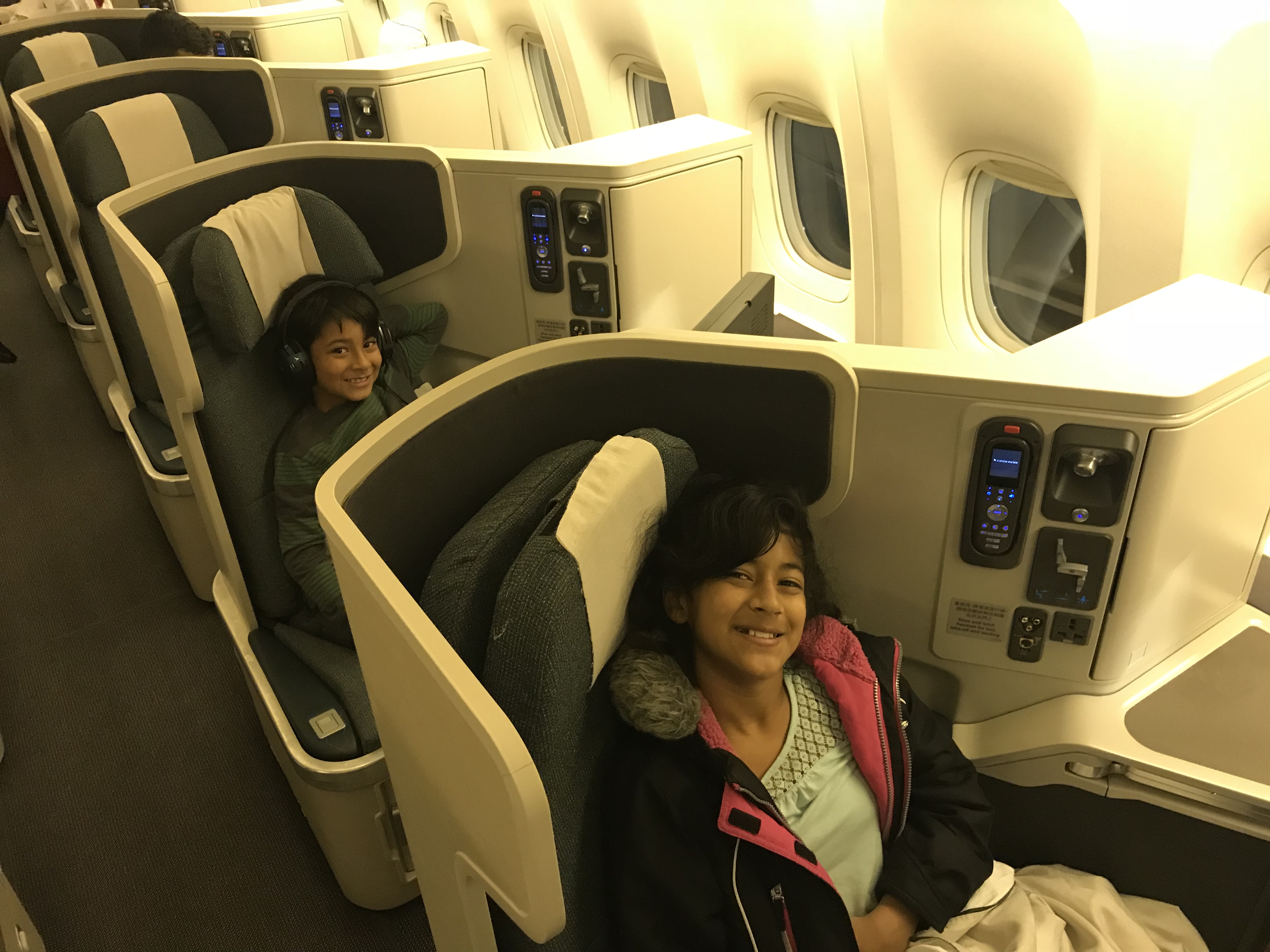 a couple of kids sitting in an airplane